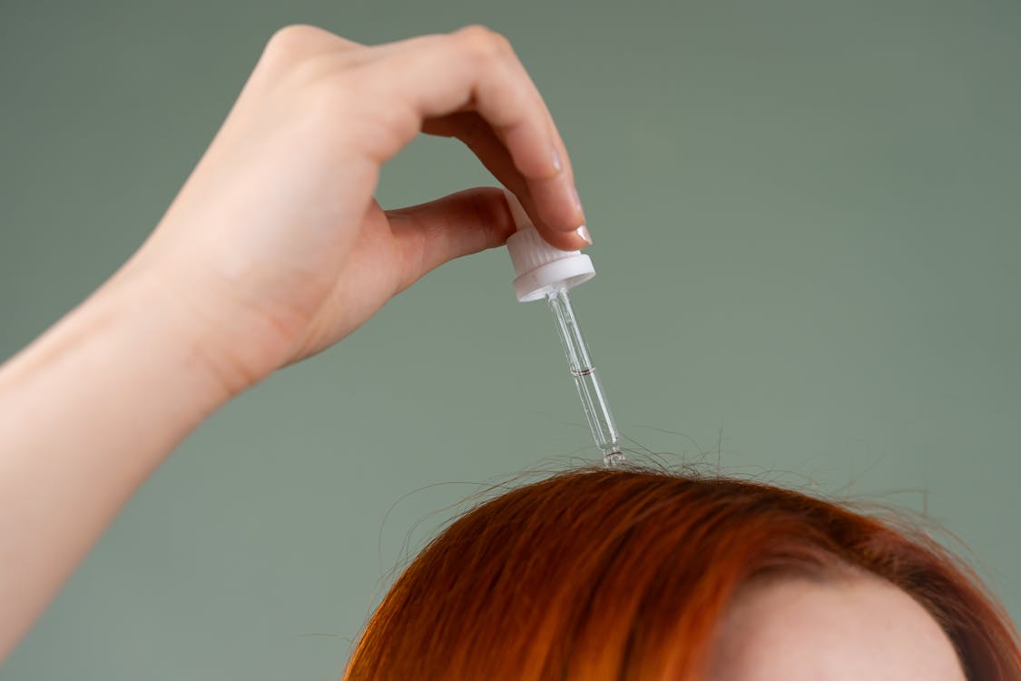 Female hair loss treatment serum application